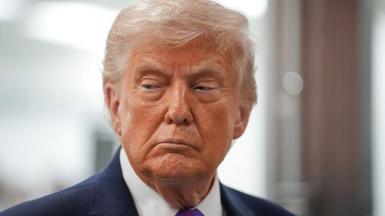 close-up of Donald Trump's face, looking off to the side