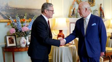 King Charles III shakes hands with Sir Keir Starmer during an audience at Buckingham Palace