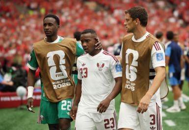 Qatar's Assim Madibo is comforted by team-mates after getting sent off in their World Cup game against Canada in 2026