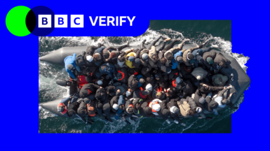 An overhead photo of an inflatable carrying migrants across the water