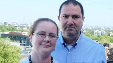 A man and woman looking directly at the camera