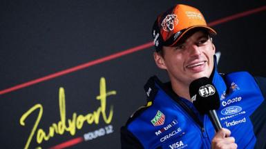 Max Verstappen holds a microphone during the drivers' news conference at Zandvoort 