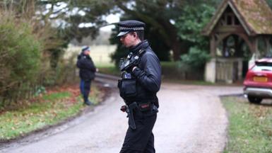Police officers stand guard near the entrance to Wood Farm, the home of Andrew Mountbatten-Windsor on February 19, 2026 in Sandringham, Norfolk
