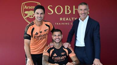 New Arsenal signing Bruno Guimaraes poses for a photograph with manager Mikel Arteta and sporting director Andrea Berta