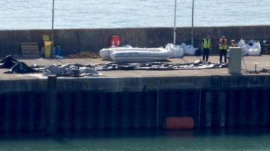 A deflated dinghy is seen on the quayside in Dover, Kent. A record 230 migrants arrived after crossing the Channel to the UK in a single boat on Monday