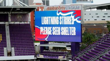 Big screen saying 'lightning strikes please seek shelter'
