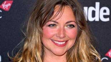Singer Charlotte Church smiles for the cameras on the red carpet of an awards event