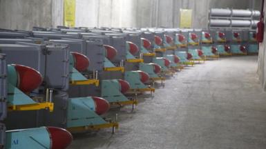 Missiles sit on trailers inside a concrete bunker.