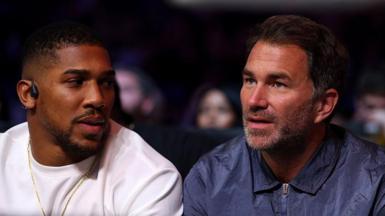 Eddie Hearn and Anthony Joshua in conversation at ringside