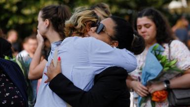 Two women hug at a vigil for the Southport attack