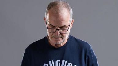 Marcelo Bielsa stares downwards during Uruguay's official World Cup photo shoot