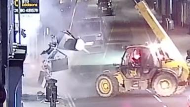 Telehandler lifts cash machine from building society.