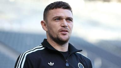 Kieran Trippier in a Newcastle United training tracksuit top, which is in club colours - black with white trim