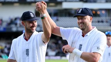 Josh Tongue and Ollie Robinson hold their hands aloft