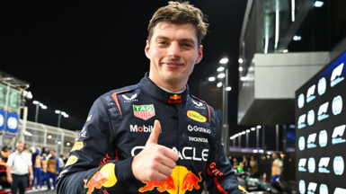 Max Verstappen, in Red Bull racing outfit, gives a thumbs-up salute