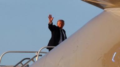 President Donald Trump waves as he boards Air Force One