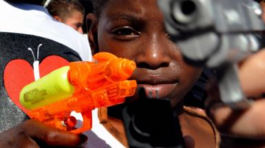 A boy plays with toy guns at a symbolic event in Medellín in 2009.
