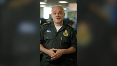 A NHS paramedic speaks to the camera