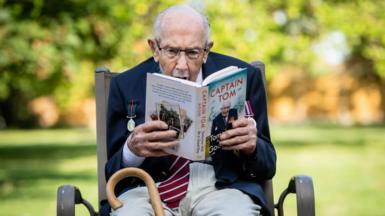 Captain Sir Tom Moore reading his autobiography