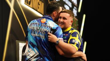 Luke Littler (right) embraces Luke Humphries after victory in the final on night thirteen of the BetMGM Premier League 2026 at P&J Live, Aberdeen.