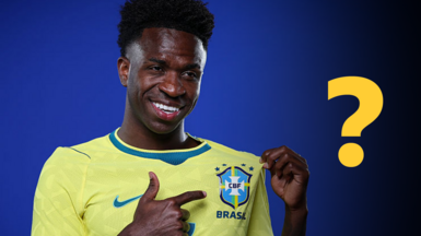 Vinicius Junior pointing to a Brazil badge on his shirt