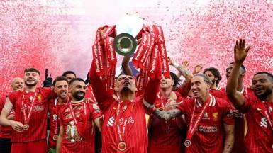 Liverpool captain Virgil van Dijk lifts the Premier League trophy after the game against Crystal Palace at Anfield