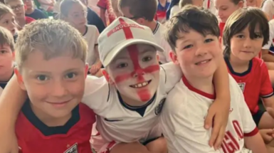 Children smiling at a school in England merch