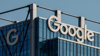 The Google logo in white lettering is visible on a dark glass office building in the US city of Atlanta, Georgia