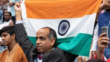 A supporter of Prime Minister Narendra Modi holding the Indian flag during the Howdy Modi event in Houston in 2019. 