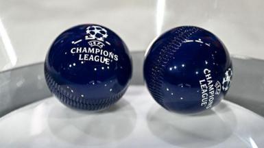 This photograph shows the draw balls bearing the Champions League logo
