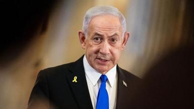 Benjamin Netanyahu in a black suit and blue tie
