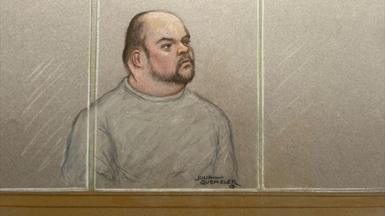 A court sketch of Gavin Plumb, a man with a bald head and dark goatee and moustache, watching court proceedings from behind glass 