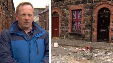 BBC News correspondent Chris Page on left side, debris on street with Union flag on window on right side
