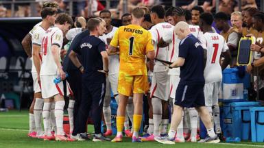 England players gather on the touchline for a hydration break during the 4-2 victory over Croatia at the 2026 FIFA World Cup in  Dallas, Texas
