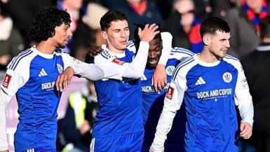 Macclesfield's players celebrate during the match against Crystal Palace