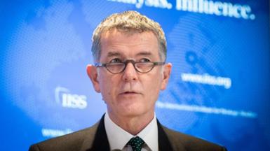 Richard Moore in glasses and a suit