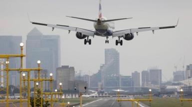 A plane lands at a London airport.