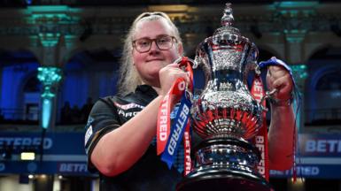 Beau Greaves celebrates winning the Women's Matchplay at Winter Gardens in Blackpool by lifting the silver trophy aloft