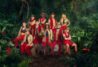 The cast of I'm a Celebrity 2024 pose together wearing their jungle outfits against a jungle backdrop full of plants