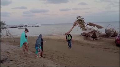 Tourists being led from the emergency waiting room down the beach