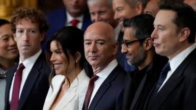 Appearing at the second inauguration of Donald Trump, from left to right: Mark Zuckerberg in a black suit, white dress shirt and red necktie; Jeff Bezos in a navy suit, white dress shirt and red neck tie; Sundar Pichai in an all black suit, shirt and neck tie; Elon Musk in a black suit, white dress shirt and navy neck tie