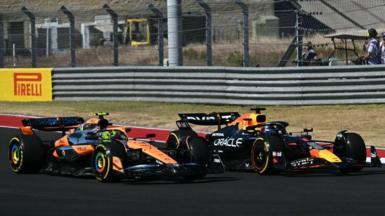 Max Verstappen goes up the inside of Lando Norris' McLaren at the first corner of the United States Grand Prix