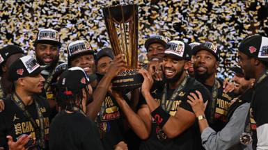 New York Knicks players holding the NBA Championship trophy