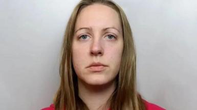 Police custody image of Lucy Letby with long blond hair and red top.