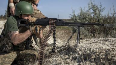 A Ukrainian fires a machine gun