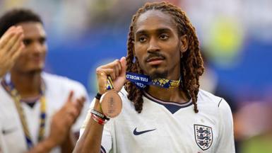 Djed Spence holding World Cup bronze medal