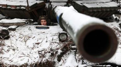 A Ukrainian soldier looks out from a tank near Bakhmut, eastern Ukraine