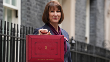 Rachel Reeves standing in Downing Street with a ministerial red box containing her Budget speech