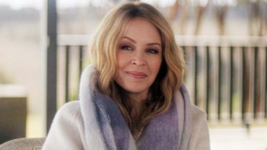 Kylie Minogue smiling at the camera while wearing a fur coat in the new three-part Netflix documentary, Kylie