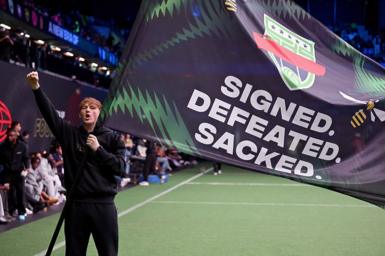 AngryGinge holds a flag that reads 'Signed. Defeated. Sacked'.